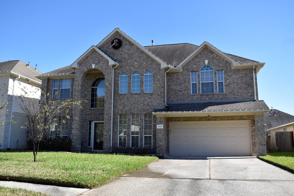 Clean single-family home exterior with a well-kept driveway